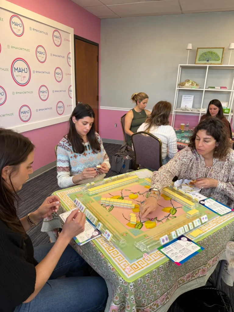 women concentrating at a mahjong game table