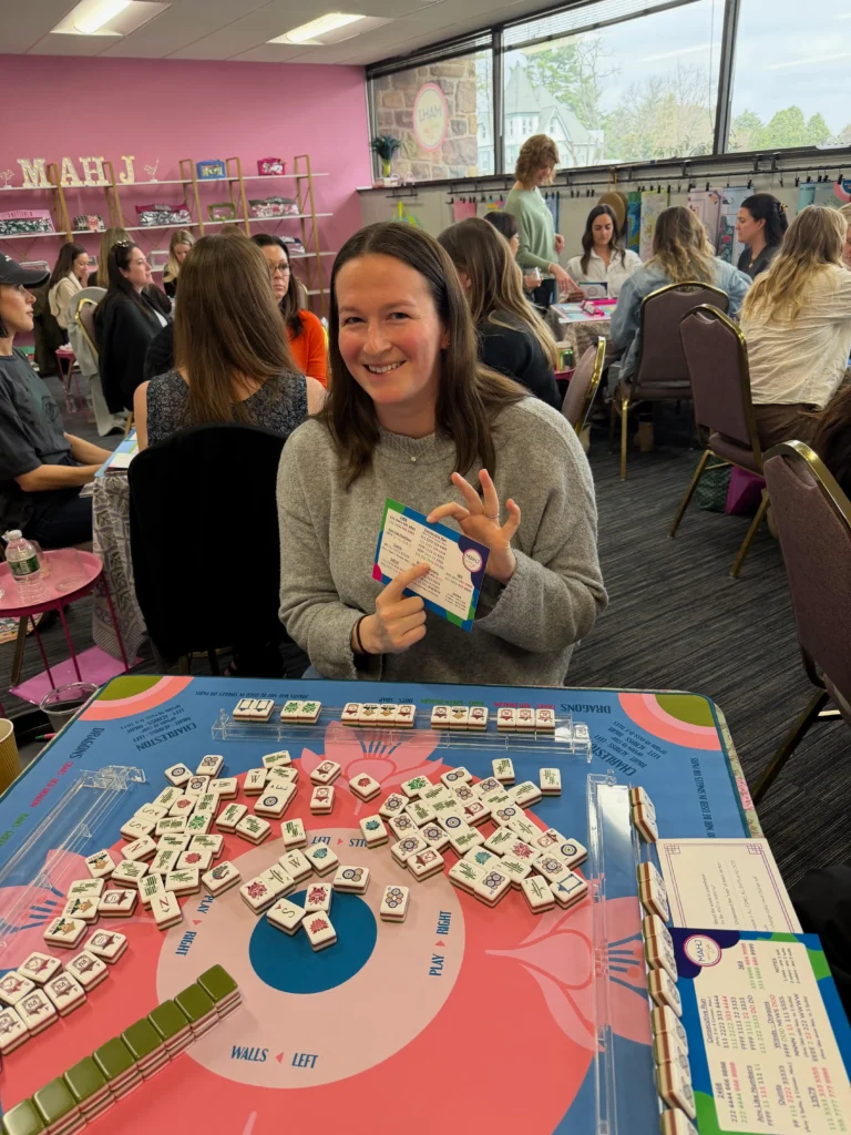 Woman holding a mahjong card
