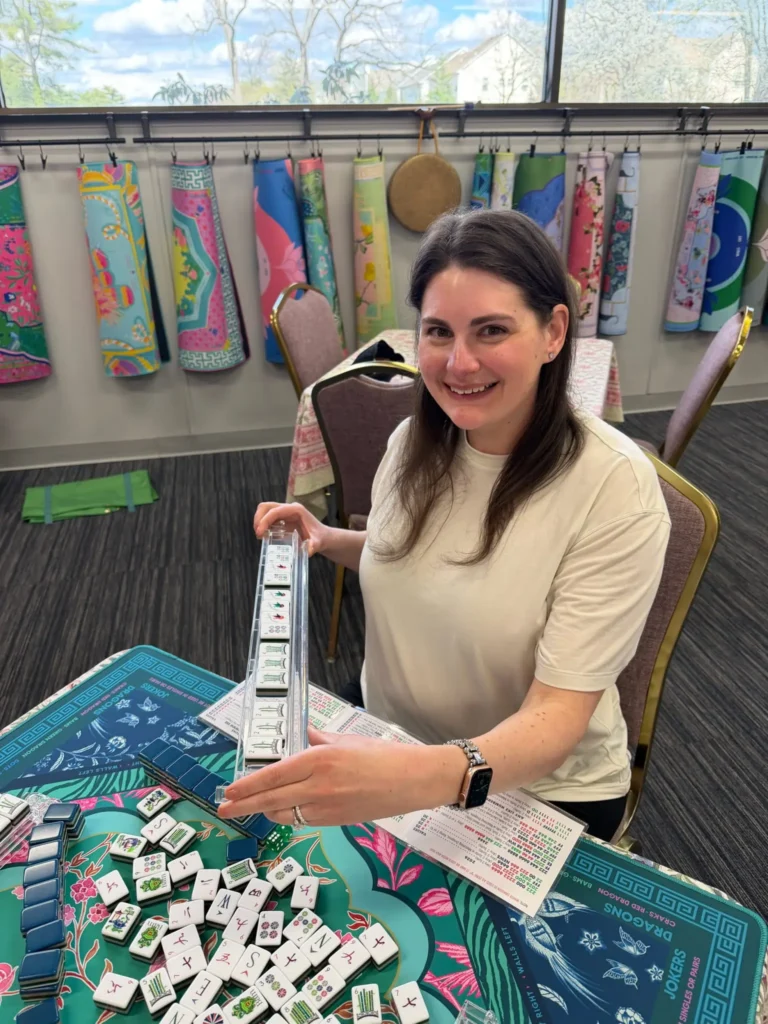Woman in a white top with mahjong tiles
